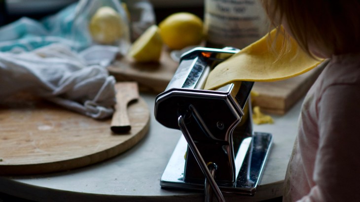 Rolling dough through a pasta machine