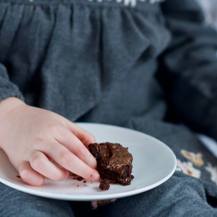 child eating a fudgy brownie