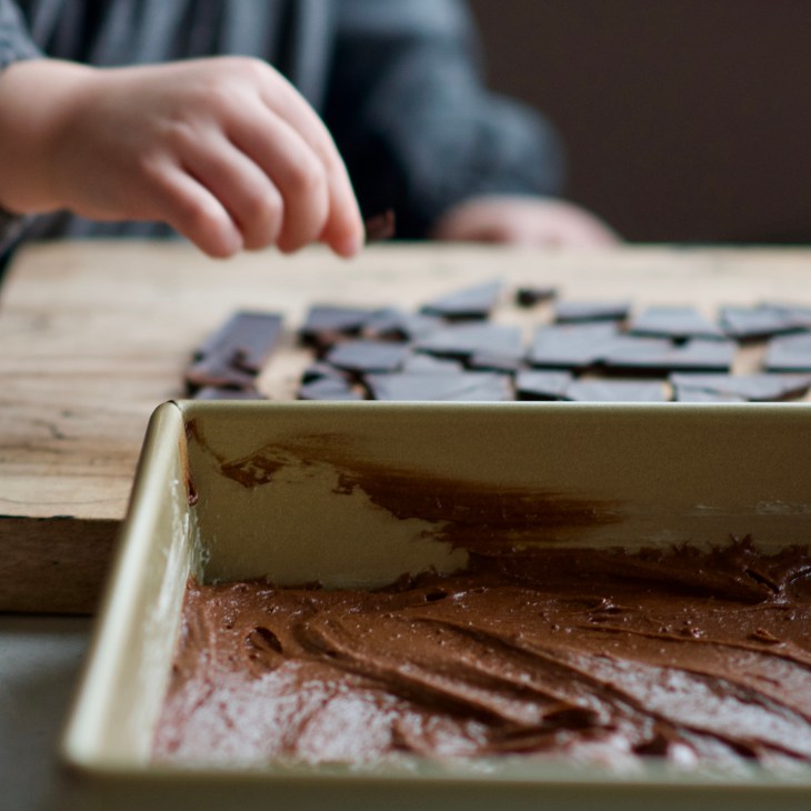 placing shards of dark chocolate onto blood orange brownie batter