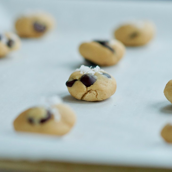 chocolate chip cookie dough on a tray with sea salt on top