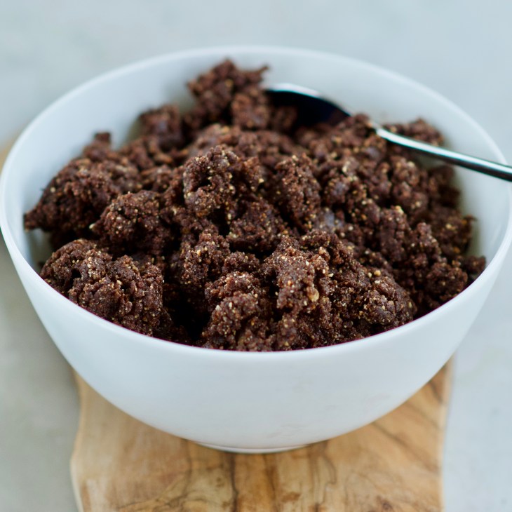 date almond bar dough in a white bowl